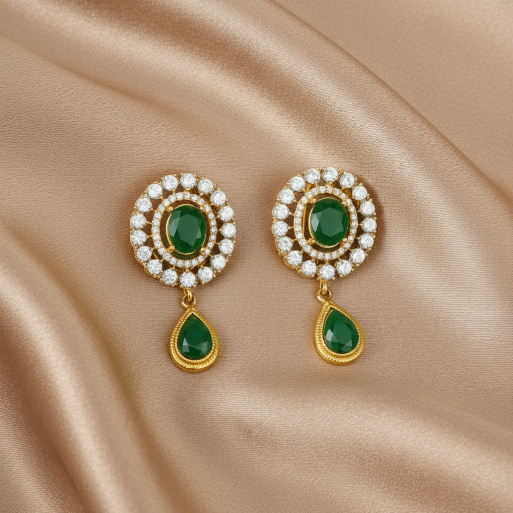 A pair of emerald green and gold-colored earstuds with sparkling CZ Zircons.