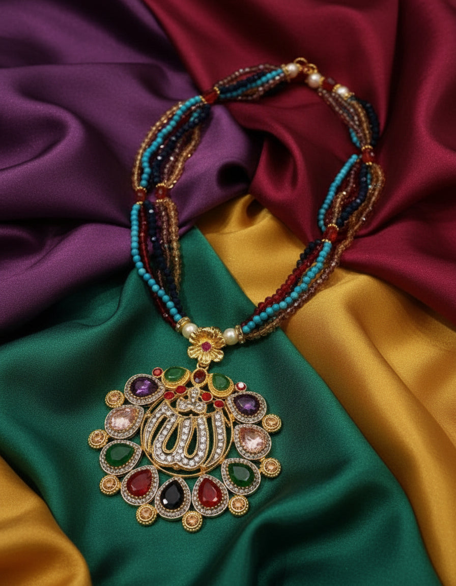 Colorful beaded necklace with a large, ornate ALLAH name pendant and featuring gemstones on a white background.