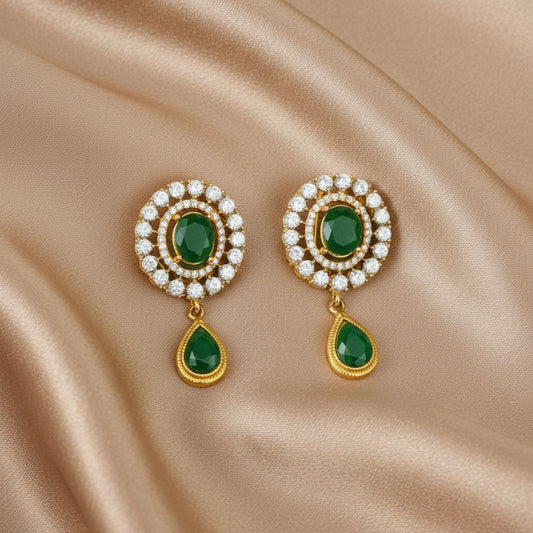 A pair of emerald green and gold-colored earstuds with sparkling CZ Zircons.