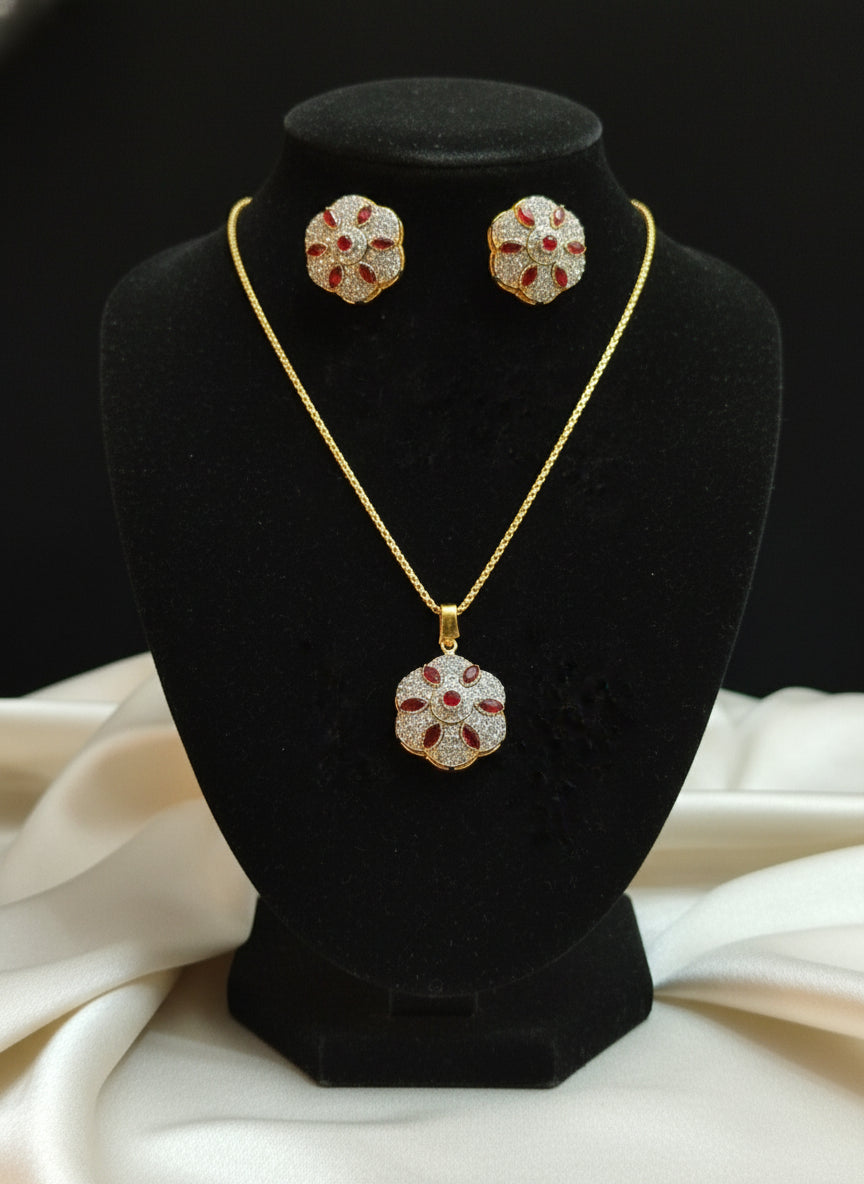 Set of gold earrings with red gemstones 